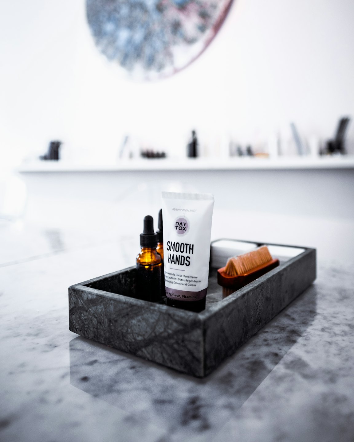 Beauty products in a tray on marble.
