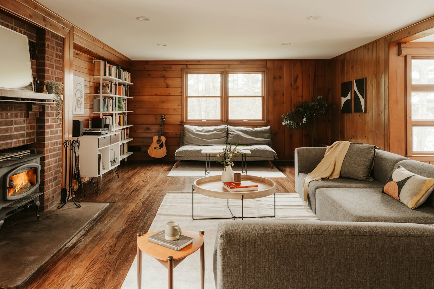 Cozy living room with a wood-burning stove and sofas.
